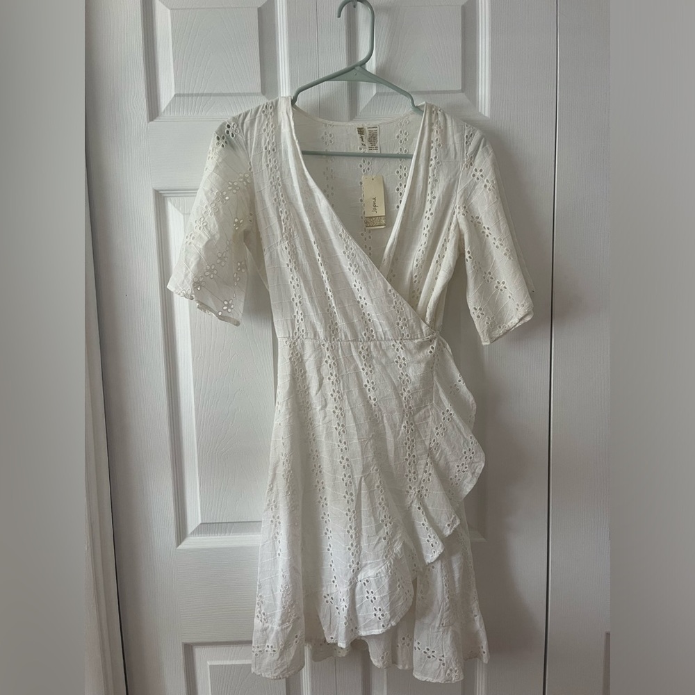 White eyelet wrap dress. Never worn with tags